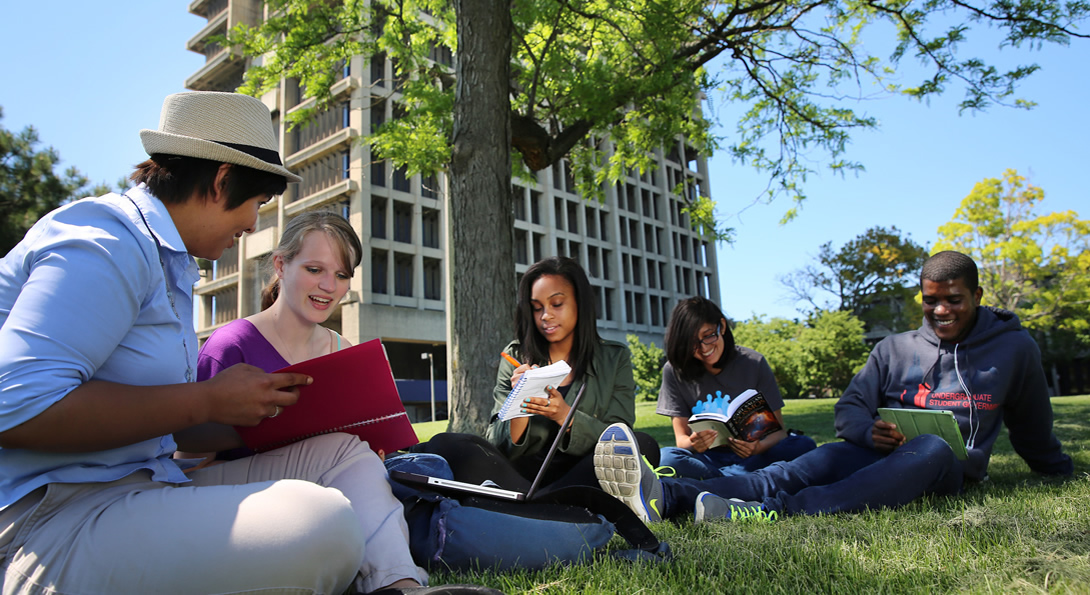 Students studying in front of University Hall.